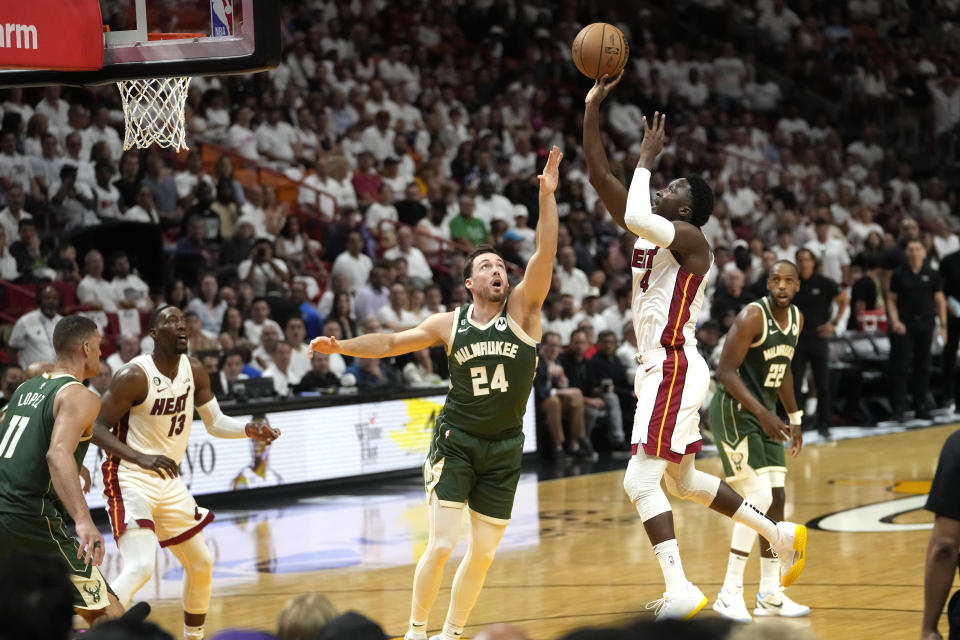 Miami Heat guard Victor Oladipo (4) shoots as Milwaukee Bucks guard Pat Connaughton (24) defends during the first half of Game 3 in a first-round NBA basketball playoff series, Saturday, April 22, 2023, in Miami. (AP Photo/Lynne Sladky)