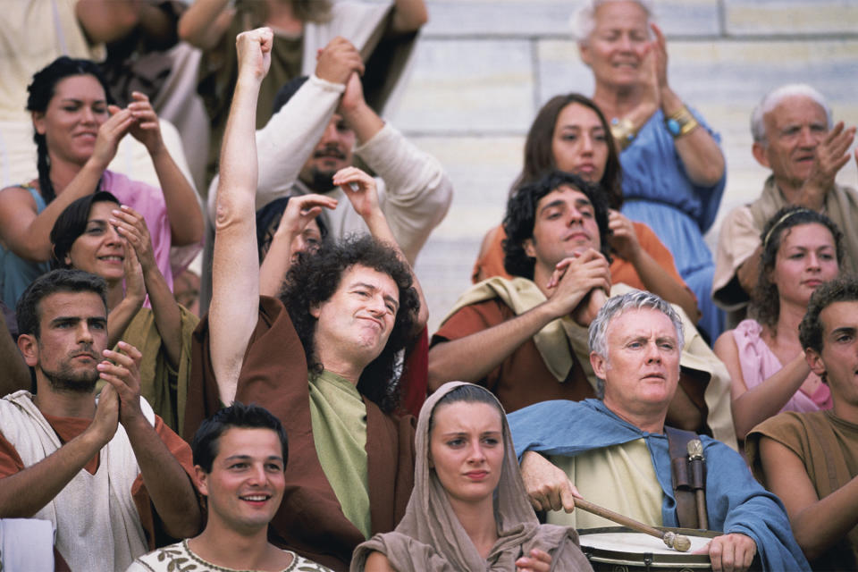 Queen’s Brian May and Roger Taylor in character as part of the crowd.