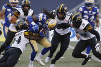 Winnipeg Blue Bombers wide receiver Janarion Grant (80) is tackled by Hamilton Tiger-Cats' Desmond Lawrence (24) during the first half of a Canadian Football League game Thursday, Aug. 5, 2021, in Winnipeg, Manitoba. (John Woods/The Canadian Press via AP)