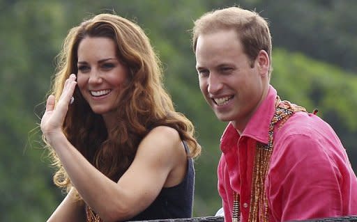 Prince William and his wife Catherine smile as they arrive at Marapa Island, on the Solomon Islands, on September 17. A French court is set to rule Tuesday on whether to ban the resale of photos of Catherine sunbathing topless, after the British royal family sought an injunction