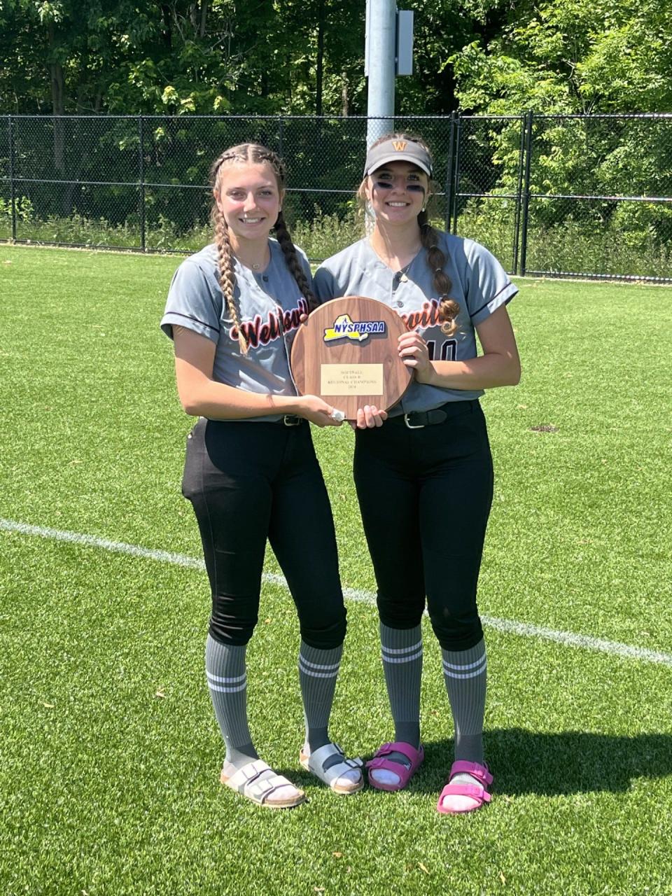 Wellsville's softball sisters Emily, left, and Lindsay Stuck with the NYSPHSAA Class B region championship plaque.