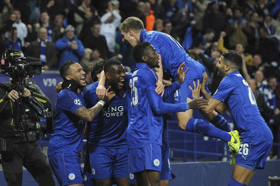 Leicester's Wes Morgan, second left, celebrates with team mates after he scores a goal during the Champions League round of 16 second leg soccer match between Leicester City and Sevilla at the King Power Stadium in Leicester, England, Tuesday, March 14, 2017. (AP Photo/Rui Vieira)