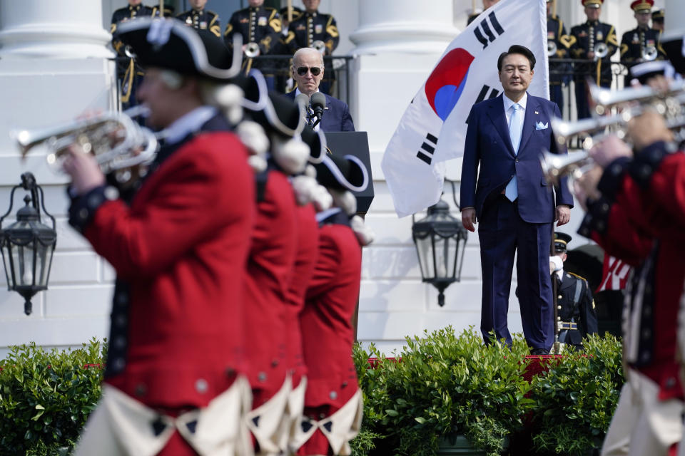 President Joe Biden and South Korea's President Yoon Suk Yeol stand on stage and watch the United States Army Old Guard Fife and Drum Corps march past, during a State Arrival Ceremony on the South Lawn of the White House Wednesday, April 26, 2023, in Washington. (AP Photo/Evan Vucci)