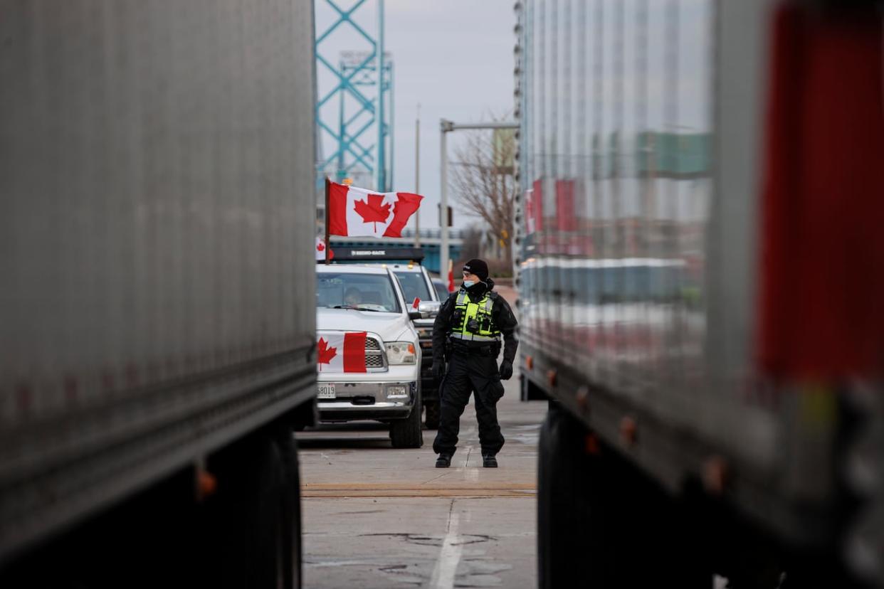 Police cleared vehicles from a blockade of the Ambassador Bridge in Windsor, Ont., on Saturday, Feb. 12, 2022, though a number of protesters remained at the border crossing at that time. (Evan Mitsui/CBC - image credit)