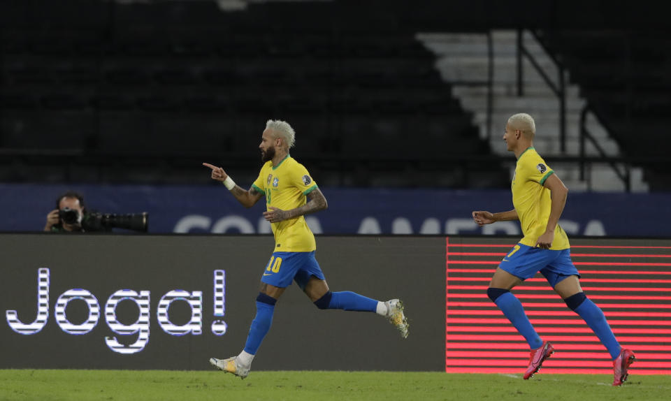 Brazil's Neymar, left, celebrates after scoring his side's 2nd goal during a Copa America soccer match against Peru at Nilton Santos stadium in Rio de Janeiro, Brazil, Thursday, June 17, 2021.(AP Photo/Silvia Izquierdo)