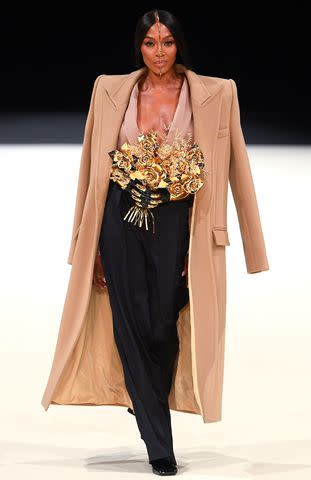 <p>Giovanni Giannoni/WWD via Getty Images</p> Naomi Campbell walks the Balmain Menswear Fall 2024 show on Jan. 20