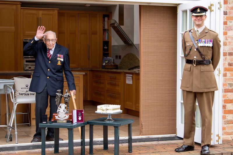 Former British Army Officer Captain Tom Moore, appointed the first Honorary Colonel of the Army Foundation College in Harrogate, stands with Lieutenant Colonel Thomas Miller next to his medals and gifts that he received for his birthday in Bedford