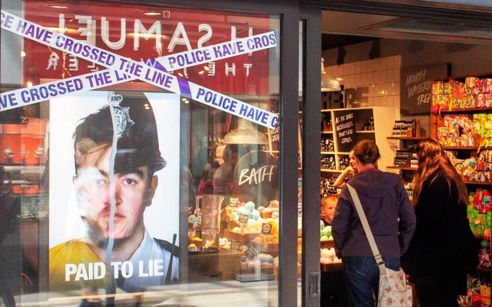 Lush store window display showing the anti-police 'paid to lie' campaign