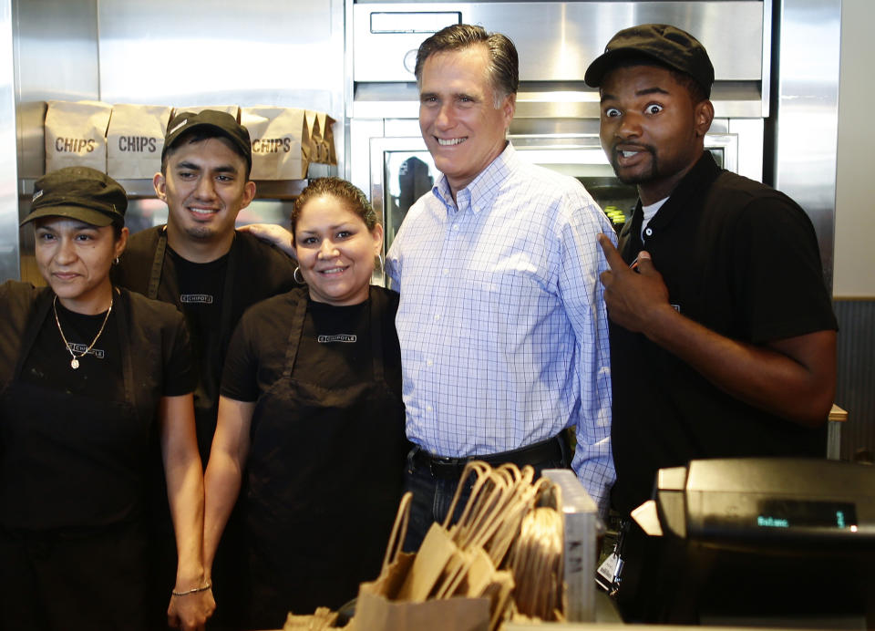 Republican presidential candidate, former Massachusetts Gov. Mitt Romney poses for a photo with workers as he makes an unscheduled stop at a Chipotle restaurant in Denver, Tuesday, Oct. 2, 2012. (AP Photo/Charles Dharapak)