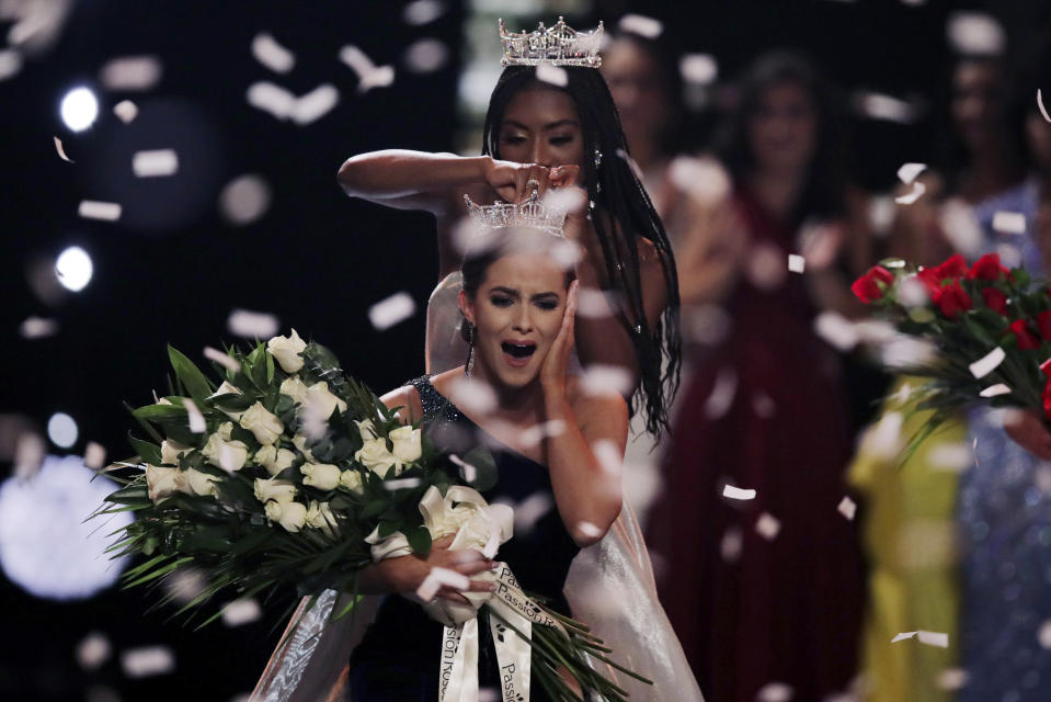 Camille Schrier, of Virginia, reacts reacts as she is crowned after winning the Miss America competition at the Mohegan Sun casino in Uncasville, Conn., Thursday, Dec. 19, 2019. At rear is 2019 Miss. America Nia Franklin. (AP Photo/Charles Krupa)