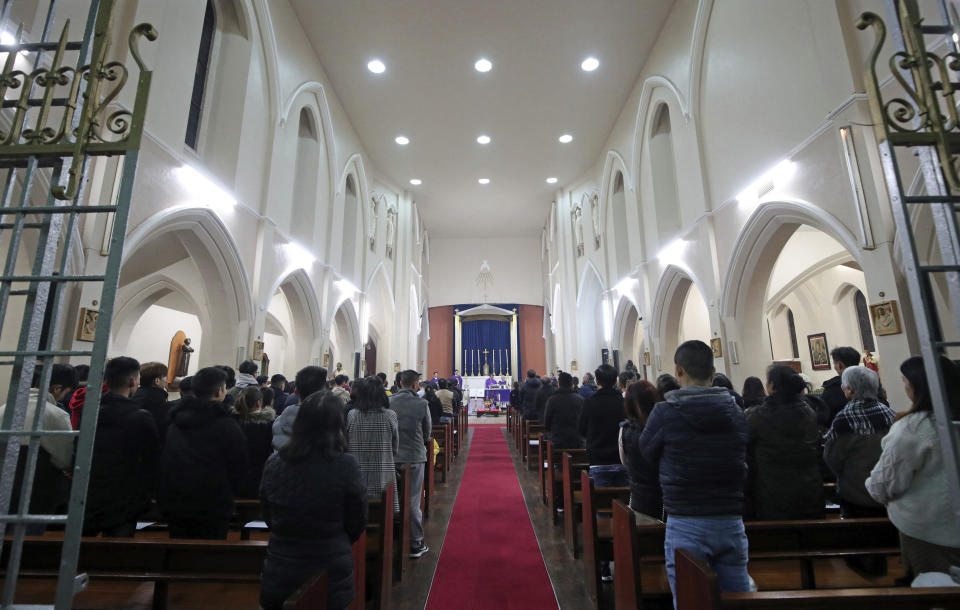 The priest of the Vietnamese Catholic Cathedral in east London, Father Simon Thang Duc Nguyen, speaks at The Holy Name and Our Lady of the Sacred Heart Church, London's Vietnamese church, in east London. Saturday Nov. 2, 2019, during a service and vigil to honor the 39 victims who died in a refrigerated truck container found on Oct. 23. The community is mourning the unidentified victims, who were trying to enter Britain in hopes of finding opportunity. (Yui Mok/PA via AP)