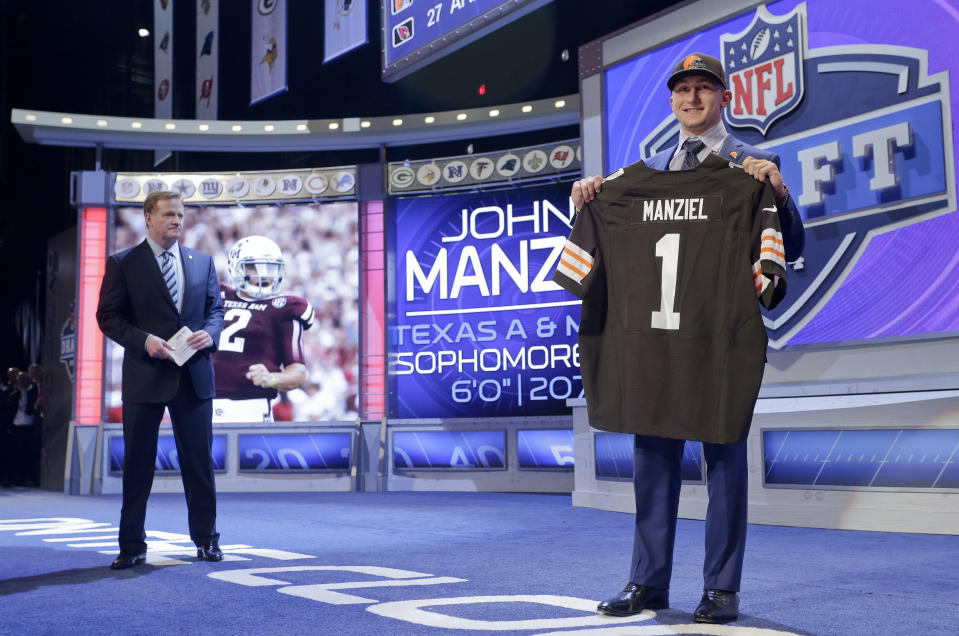 Texas A&M quarterback Johnny Manziel poses for photos after being selected by the Cleveland Browns as the 22nd pick in the first round of the 2014 NFL Draft, Thursday, May 8, 2014, in New York. (AP Photo/Craig Ruttle)