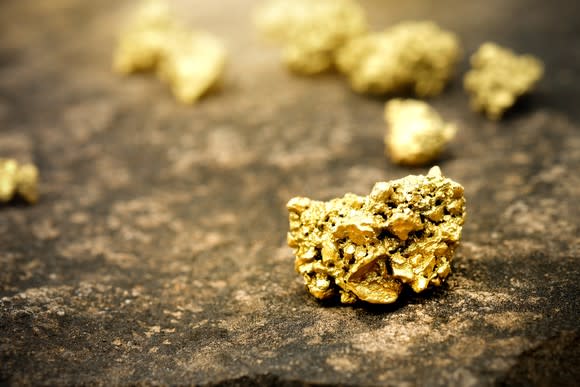 Gold ore on a stone floor.