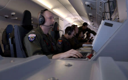 REFILE- CORRECTING SPELLING Members of the U.S. Navy, aboard the Boeing P-8A Poseidon plane, take part in the search for the ARA San Juan submarine missing at sea as they fly over the South Atlantic Ocean, Argentina November 22, 2017. Picture taken November 22, 2017. REUTERS/Magali Cervantes