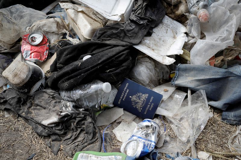 A Haitian passport is seen in a pile of trash near the International Bridge between Mexico and the U.S., where migrants seeking asylum in the U.S. are waiting to be processed, in Del Rio