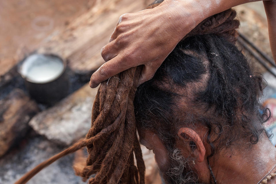 KATHMANDU, NEPAL - FEBRUARY 17:  A Shadu, or holy man, wraps his hair in a bun inside Pashupatinath temple during the celebration of the Maha Shivaratri festival on February 17, 2015 in Kathmandu, Nepal. 