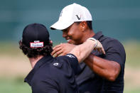 FARMINGDALE, NY - AUGUST 23: Tiger Woods (R) and Rory McIlroy of Northern Ireland joke around on the course as they walk up the 18th hole fairway during the First Round of The Barclays on the Black Course at Bethpage State Park August 23, 2012 in Farmingdale, New York. (Photo by Kevin C. Cox/Getty Images)