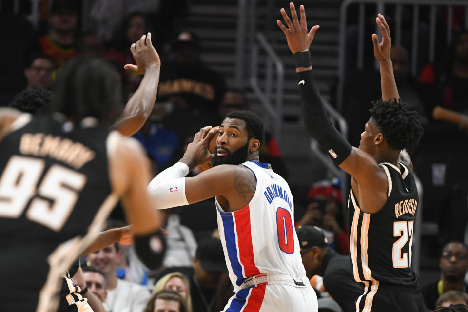 Detroit Pistons center Andre Drummond (0) looks to pass as Atlanta Hawks forward Cam Reddish, right, defends during the first half of an NBA basketball game Saturday, Jan. 18, 2020, in Atlanta. (AP Photo/John Amis)