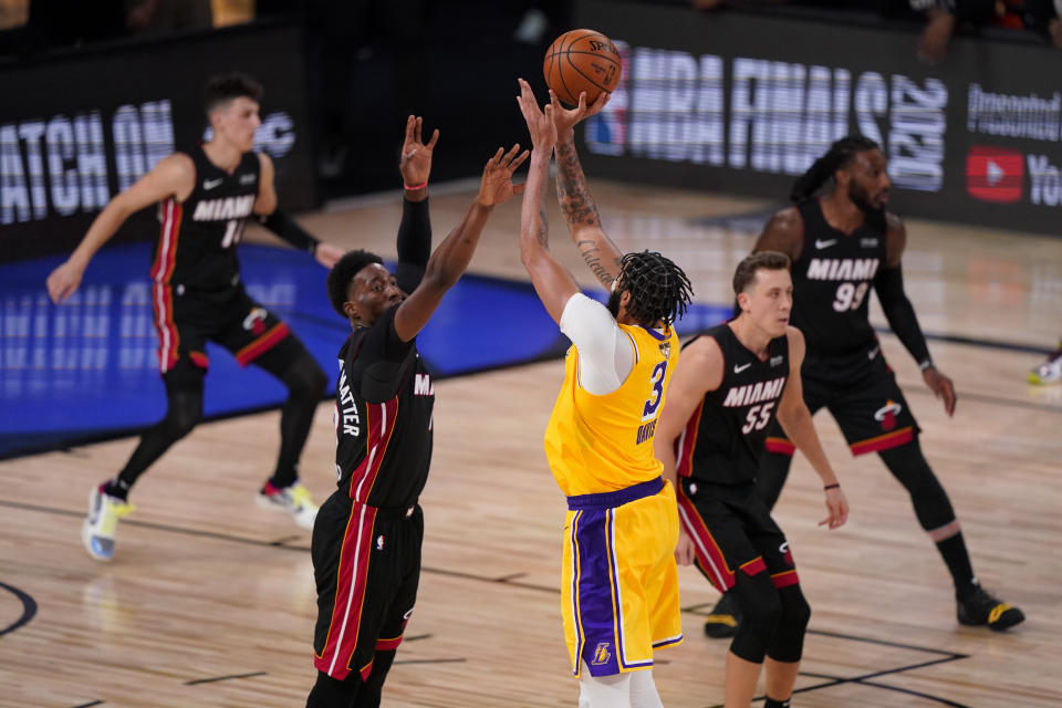 Los Angeles Lakers forward Anthony Davis makes a 3-point basket with 40 seconds left on the clock in Game 4 of basketball's NBA Finals against the Miami Heat Tuesday, Oct. 6, 2020, in Lake Buena Vista, Fla. (AP Photo/Mark J. Terrill)