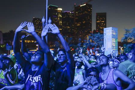 Attendees dance during the Made in American music festival in Los Angeles, California August 31, 2014. REUTERS/Jonathan Alcorn