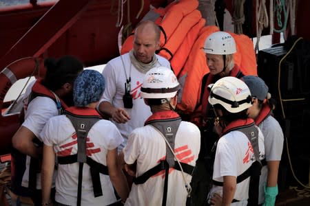 Staff members speak aboard the Ocean Viking