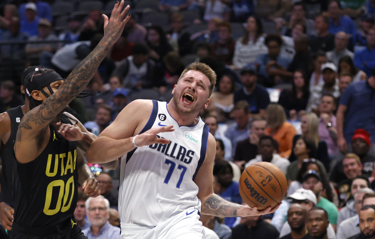 DALLAS, TX - NOVEMBER 2: Luka Doncic #77 of the Dallas Mavericks drives inside against Jordan Clarkson #00 of the Utah Jazz in the first half at American Airlines Center on November 2, 2022 in Dallas, Texas. NOTE TO USER: User expressly acknowledges and agrees that, by downloading and or using this photograph, User is consenting to the terms and conditions of the Getty Images License Agreement. (Photo by Ron Jenkins/Getty Images)