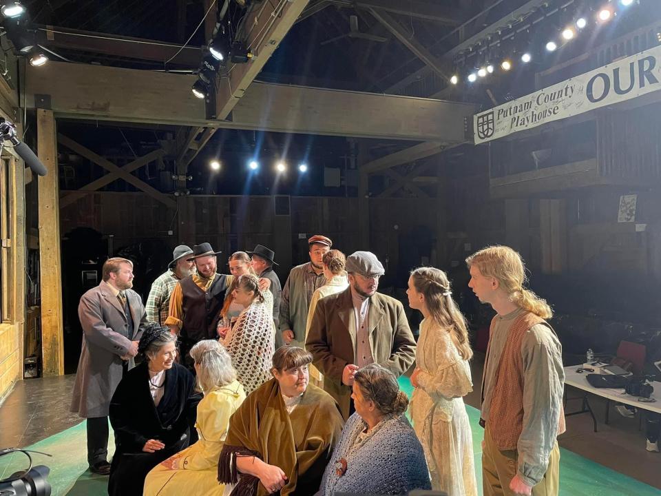 Onstage at the Putnam County Playhouse, actors stand in costume before filming a scene on Dec. 9, 2023.