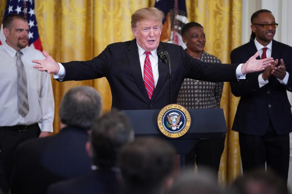 Donald Trump celebrates passage of the First Step Act at the White House with formerly incarcerated people on 1 April, 2019. (Getty Images)