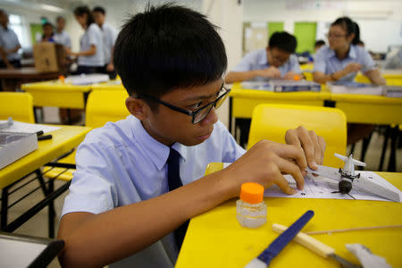 A student assembles a model aeroplane during an enrichment class at a secondary school in Singapore October 27, 2016. Picture taken October 27, 2016. REUTERS/Edgar Su