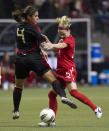 VANCOUVER, CANADA - JANUARY 27: Kelly Parker #15 of Canada and Alina Garciamendez #4 of Mexico battle for the loose ball during the first half of semifinals action of the 2012 CONCACAF Women's Olympic Qualifying Tournament at BC Place on January 27, 2012 in Vancouver, British Columbia, Canada. (Photo by Rich Lam/Getty Images)