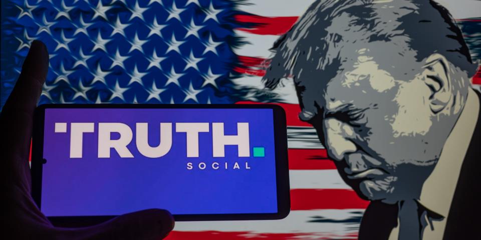 Truth Social logo displayed on a smart phone with Donald J. Trump seen in the background, in this photo illustration. On 03 September 2023 in Brussels, Belgium