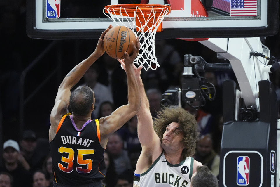 Phoenix Suns forward Kevin Durant (35) is fouled by Milwaukee Bucks center Robin Lopez during the first half of an NBA basketball game Tuesday, Feb. 6, 2024, in Phoenix. (AP Photo/Ross D. Franklin)