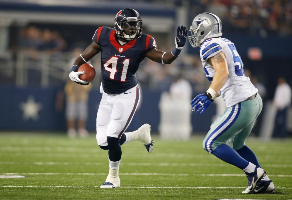 Houston Texans running back Cierre Wood (41) runs the ball Dallas Cowboys linebacker Caleb McSurdy (56) in the first quarter of the game at AT&T Stadium.