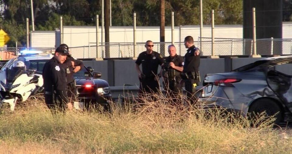 Officers surround a car involved in a collision at Brawley and Weber avenues, close to High Speed Rail construction.