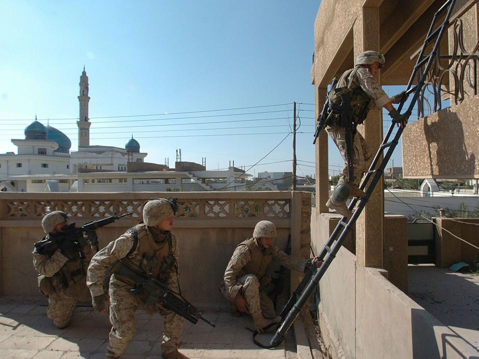 US Marine scouts of the 1st Light Armored Reconnaissance company clearing a house November 20, 2004 in Fallujah, Iraq.