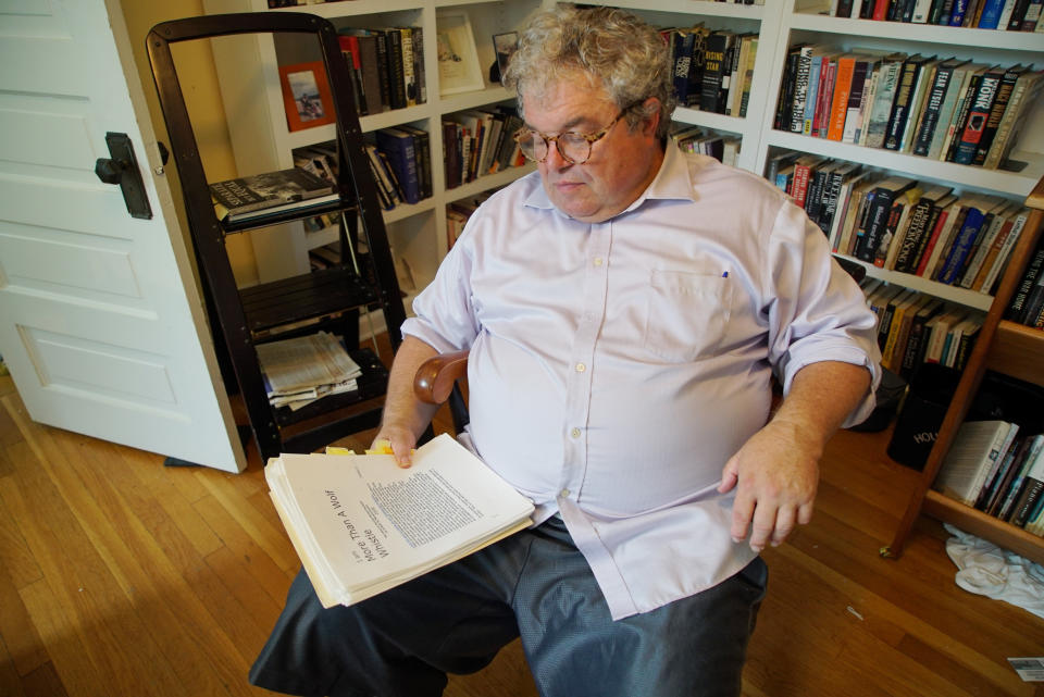 Author Timothy Tyson looks at a copy of Carolyn Bryant Donham's memoir in his home in Durham, N.C., on Thursday, July 14, 2022. (AP Photo/Allen G. Breed)