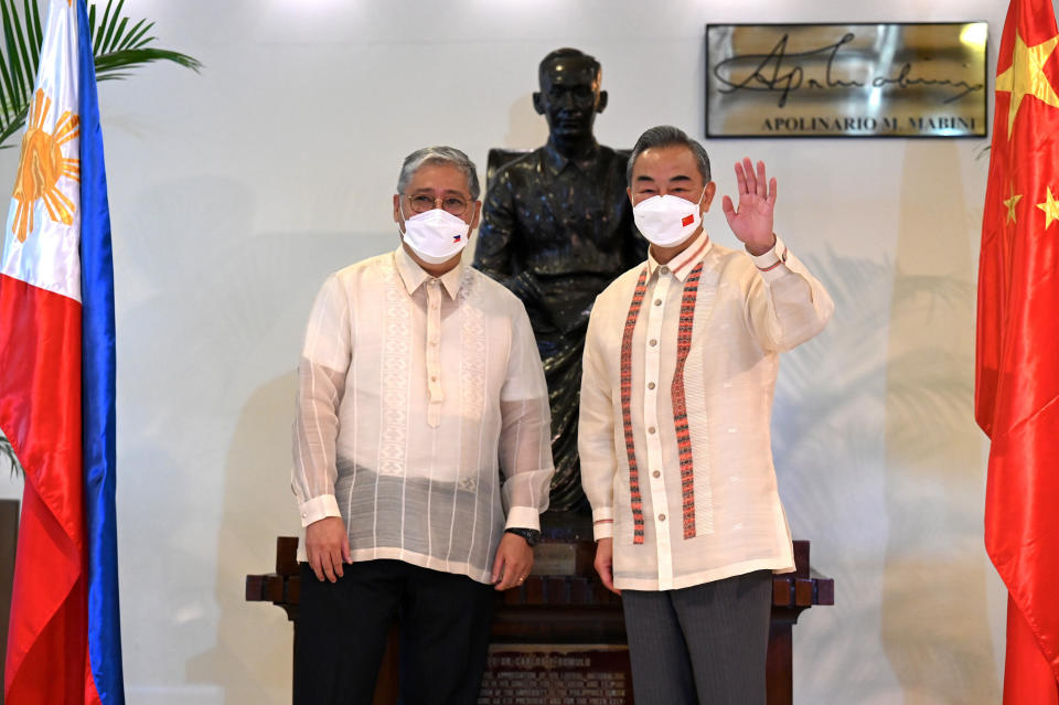 CORRECTS TO DEC. 20 IN SECOND SENTENCE, FILE - Philippine Foreign Affairs Secretary Enrique Manalo, left, and Chinese Foreign Minister Wang Yi pose for a photo before their bilateral talks at the Department of Foreign Affairs in Manila, Philippines on July 6, 2022. Wang Yi said on Wednesday, Dec. 20, 2023 the Asian power will maintain military pressure on the Philippines amid a dispute over sovereignty in the South China Sea that could involve U.S. forces defending their treaty partner. (Jam Sta Rosa/Pool Photo via AP, File)