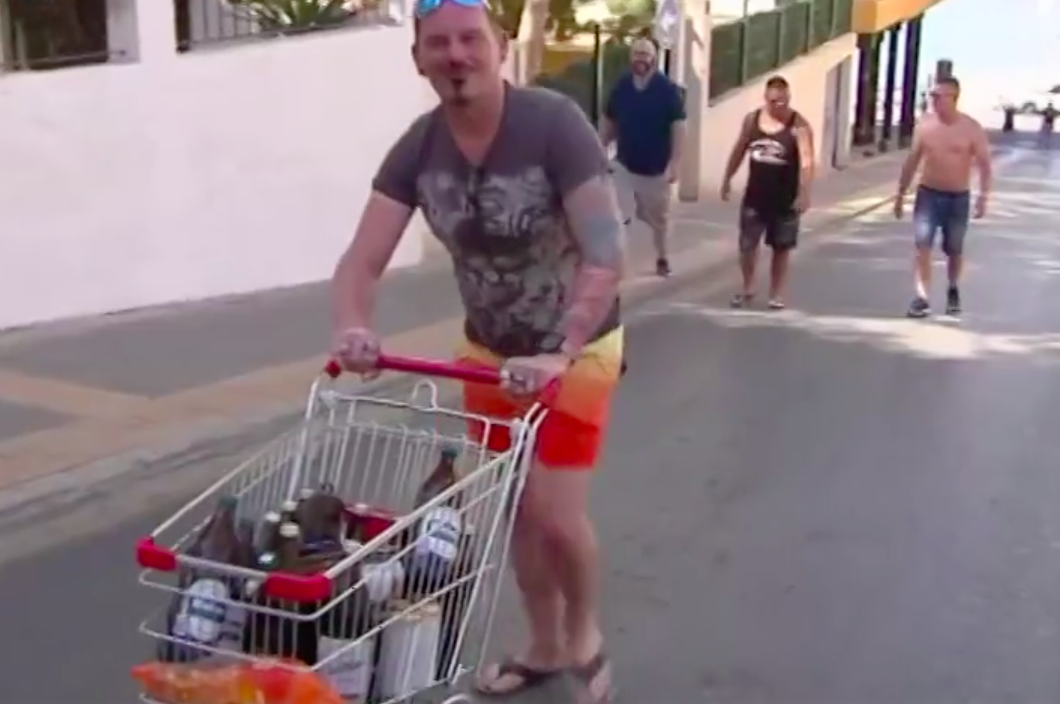 A man pushes a trolley full of drinks in Benidorm, Spain (AP)