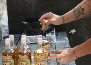 Ralph Malak, one of the founders and chief taste developer of the Three Brothers distillery, stamps a gin bottle in Smar Jbeil