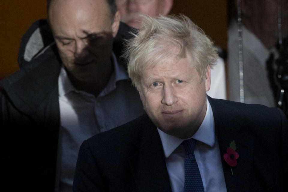 British Prime Minister Boris Johnson and his advisor Dominic Cummings, left, leave 10 Downing Street in London, and get in a car together to go to the Houses of Parliament, Monday, Oct. 28, 2019. British Prime Minister Boris Johnson says it's Parliament's fault, not his, that Britain will not be leaving the European Union as scheduled on Oct. 31. The EU has agreed to postpone Brexit until Jan. 31, 2020, after Johnson failed to get British lawmakers to ratify his divorce deal with the bloc in time to leave this week. (AP Photo/Matt Dunham)