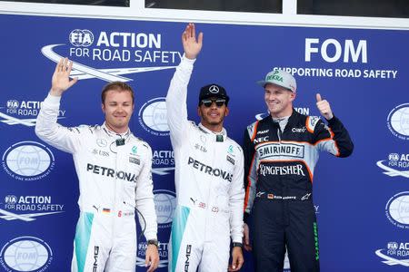 Formula One - Grand Prix of Austria - Spielberg, Austria - 2/7/16 - Mercedes Formula One drivers Nico Rosberg of Germany, Lewis Hamilton of Britain and Ferrari Formula One driver Sebastian Vettel of Germany pose for photographers after the qualifying session. REUTERS/Dominic Ebenbichler