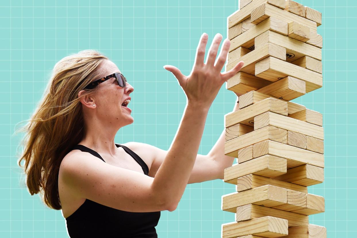 Woman playing a large outdoor Jenga game