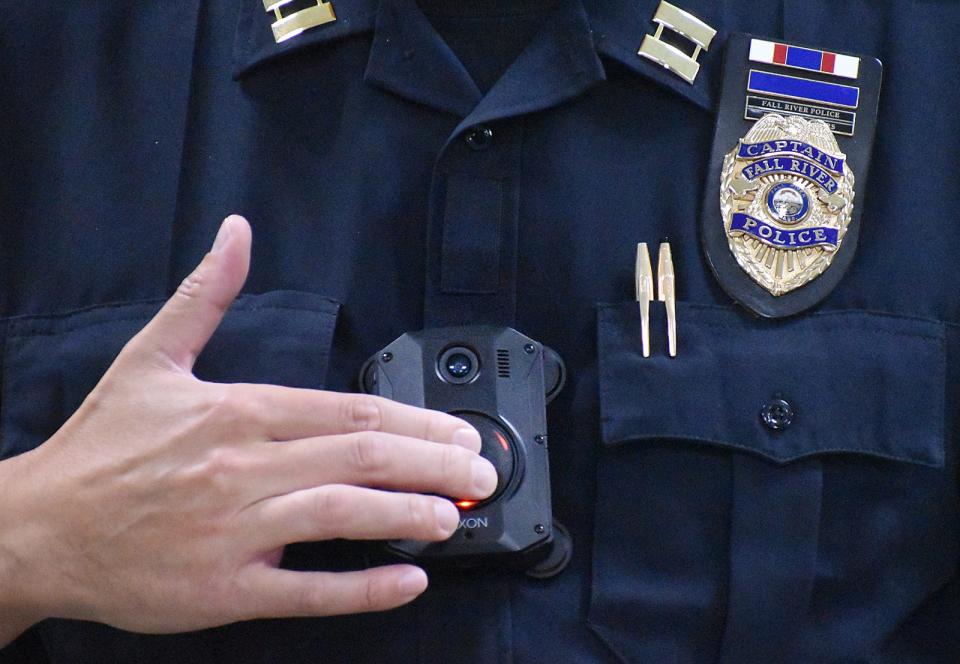 Captain J.T. Hoar demonstrates the new body cams.