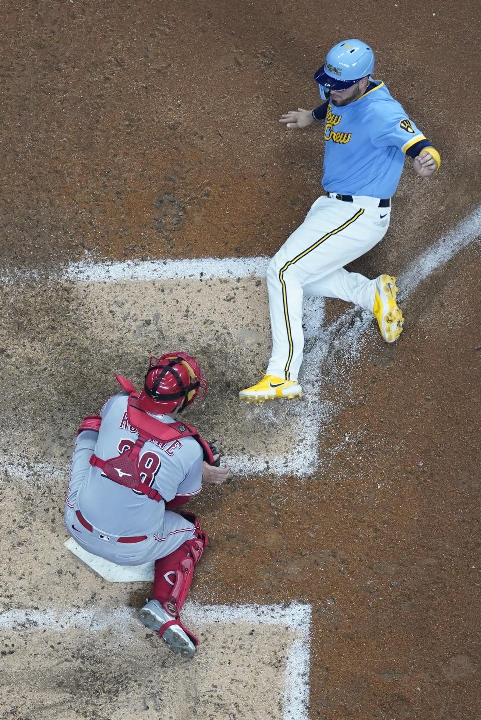 Cincinnati Reds catcher Austin Romine tags out Milwaukee Brewers' Victor Caratini at home during the sixth inning of a baseball game Saturday, Aug. 6, 2022, in Milwaukee. Caratini tried to score from second on a hit by Christian Yelich. (AP Photo/Morry Gash)