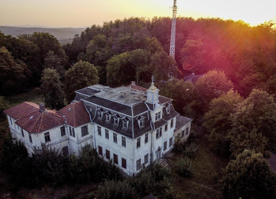 A wrecked and abandoned villa built in 1900 stands in a forest near Eisenach, eastern Germany, Monday, Sept. 21, 2020. Thirty years after Germany was reunited on Oct. 3, 1990, many once-decrepit city centers in the formerly communist east have been painstakingly restored and new factories have sprung up. But many companies and facilities didn't survive the abrupt transition to capitalism inefficient companies found themselves struggling to compete in a market economy, while demand for eastern products slumped and outdated facilities were shut down. (AP Photo/Michael Probst)