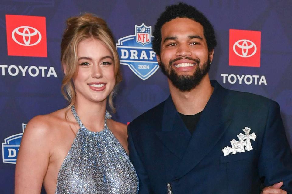 <p>Aaron J. Thornton/Getty</p> Caleb Williams and Alina Thyregod arrive to the 2024 NFL Draft on April 25, 2024 in Detroit, Michigan. 