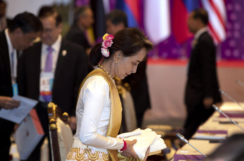 Myanmar leader Aung San Suu Kyi takes her seat during the Association of Southeast Asian Nations (ASEAN) leaders summit plenary session in Bangkok, Thailand, Saturday, June 22, 2019. (AP Photo/Gemunu Amarasinghe)