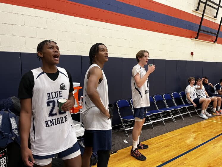 Notre Dame players (from left) Mercy Miller, Caleb Foster and Dusty Stromer watch from the bench in Las Vegas.