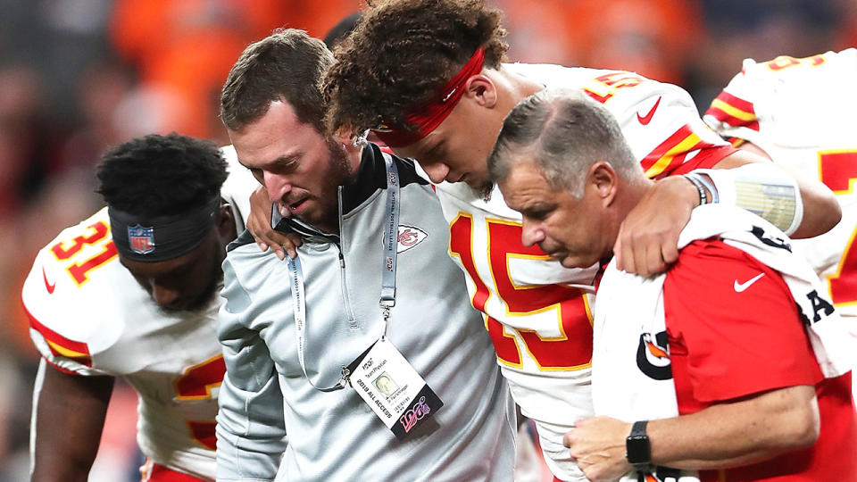 Patrick Mahomes was assisted off the field. (Photo by Matthew Stockman/Getty Images)