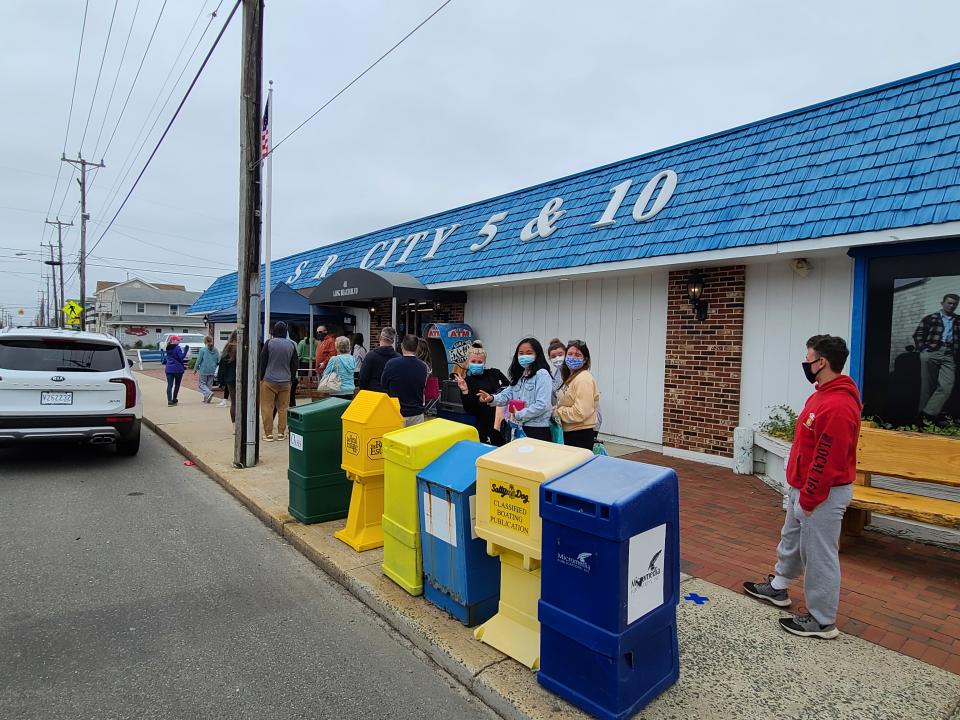 People wait in line before shopping at the Surf City 5 & 10.